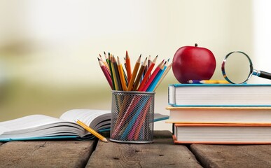 Wall Mural - Stack of vintage books and colorful pencils on the desk