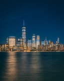 Fototapeta Nowy Jork - View of the Lower Manhattan skyline at night from Jersey City, New Jersey