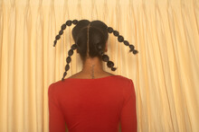 Rear View Of Black Model With Braids In Red Leotard