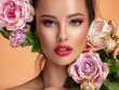 © Valua Vitaly - Beautiful white girl with flowers. Stunning brunette girl with big bouquet flowers of roses. Closeup face of young beautiful woman with a healthy clean skin. Pretty woman with bright makeup