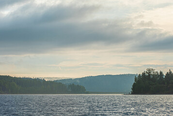Wall Mural - sunrise, sunset over the river crept a small fog over the water, beautiful colorful clouds.