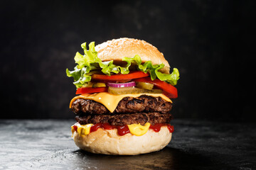 Wall Mural - Fresh tasty double hamburger on black background.