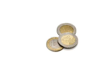 Shabby, dirty сoins one and two euros on white background. Space for text on left. Money concept. Symbol of inflation, economy and European financial system.