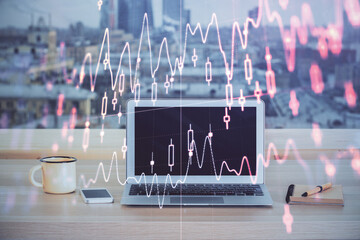 Financial chart drawing and table with computer on background. Multi exposure. Concept of international markets.