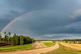 Fototapeta Tęcza - Rainbow over the road, forest and fields