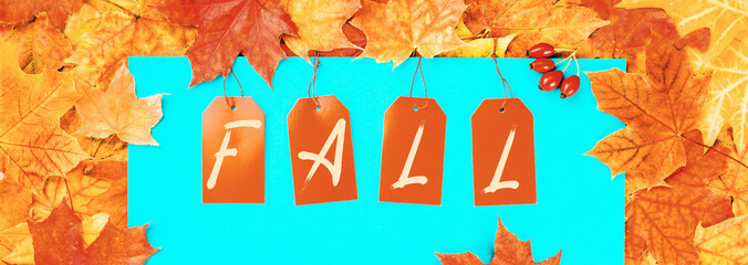Wall Mural - Fall text on price tags with maple leaves background banner. Autumn sale