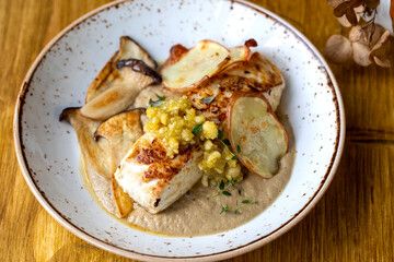 Wall Mural - Pan fried halibut with mushroom velute, hazelnut pesto and potato crisps