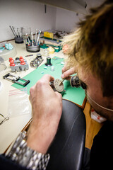 Watchmaker. Watch repair craftsman repairing watch. swiss watch repair