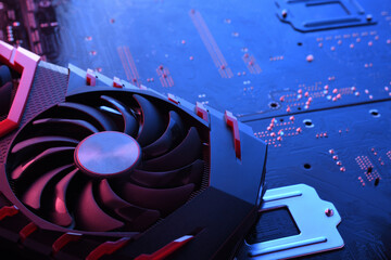 Poster - Computer game graphics card, videocard with two coolers on circuit board ,motherboard background. Close-up. With red-blue lighting