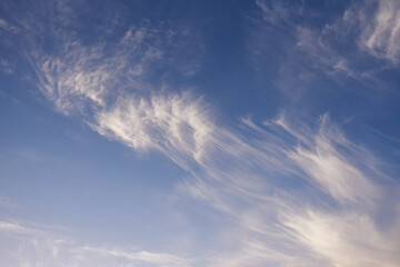 Wall Mural - Flying white clouds in the clear blue sky.