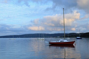 landscape of the lake of bracciano, boats still, reflections of   the clouds on the aquatic surface