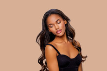 Beauty Styled Portrait Of A Young African - American Woman. Fashion African - American Girl With Curly Hair Posing In The Studio On A Beige Background. Isolated. Studio Shot. 