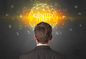 Rear view of a businessman with IDENTITY THEFT inscription, online security concept