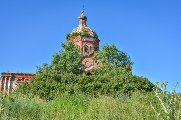 Wall Mural - Old brick abandoned orthodox Church of the Trinity Church. abandoned Trinity Church in the village of Zasechnoye. abandoned red brick church in the thicket, abandoned temple in the field