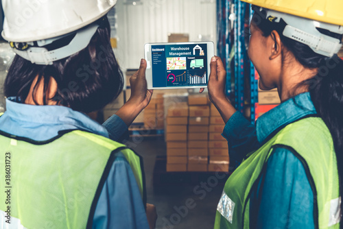 Warehouse management software application in computer for real time monitoring of goods package delivery . PC screen showing smart inventory dashboard for storage and supply chain distribution .