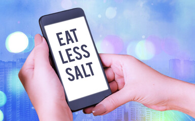 Wall Mural - Word writing text Eat Less Salt. Business photo showcasing reducing the sodium intake on the food and beverages Modern gadgets with white display screen under colorful bokeh background