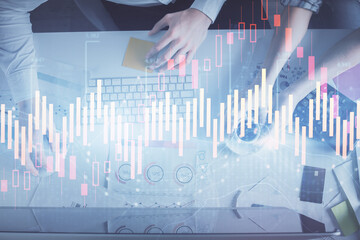 Double exposure of man and woman working together and financial chart hologram drawing. market analysis concept. Computer background. Top View.