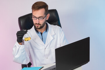 Poster - male chemist works in a laboratory and conducts research. the lab assistant is sitting next to a lap