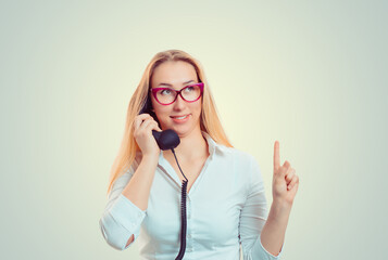 woman wagging pointing finger up talking at phone