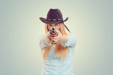 Cowgirl Aiming At Camera With Gun
