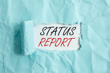 Poster - Text sign showing Status Report. Business photo showcasing summarizes the particular situation as of a stated period Rolled ripped torn cardboard placed above a wooden classic table backdrop