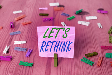 Text sign showing Let S Rethink. Business photo text an Afterthought To Remember Reconsider Reevaluate Colored crumpled rectangle shaped reminder paper light blue background