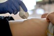 © uly.u.v  - Carrying out a medical procedure on an ultrasound machine. Wide touch sensor with a drop of gel above the baby's belly.