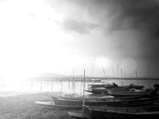 beautiful landscape view sunset time and fishing boat at reservoir, Thailand ,Black and white pictures.