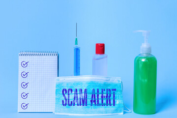 Poster - Writing note showing Scam Alert. Business concept for unsolicited email that claims the prospect of a bargain Set of medical equipment with notepad for health condition assessment