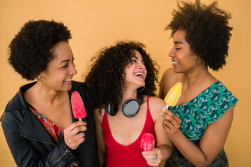 Wall Mural - Multi-ethnic group of friends enjoying summertime while eating ice cream.