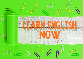 Poster - Writing note showing Learn English Now. Business concept for gain or acquire knowledge and skill of English language Rolled ripped torn cardboard above a wooden classic table
