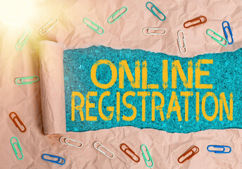 Fototapete - Writing note showing Online Registration. Business concept for System for subscribing or registering via the Internet Rolled ripped torn cardboard above a wooden classic table