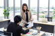 © Pornsak - Business and social distancing sitting at the same table with a plastic shield.Office new normal lifestyle.