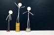 Wealth and financial inequality, income disparity concept. Human stick figures of different social class standing on stack of coins in black background.