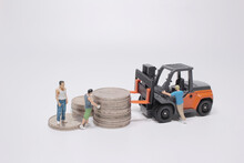The Mini Worker Use The Forklift To Move The Coins
