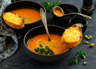 Sticker - Pumpkin soup on a gray background. Selective focus.