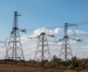 High voltage power lines against the blue sky