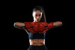 © ty - Modern with kickboxing woman in activewear and kickboxing gloves looking at you ready to fight on black background for healthy lifestyle design. Sport, healthy lifestyle.