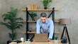 © viacheslav - Gray-haired bearded business man manager freelancer SEO working remote online distance in home office standing at table using laptop computer preparing presentation for meeting with company investors