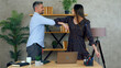 © viacheslav - Smiling woman and man greet elbows employees work together with laptop computer in office