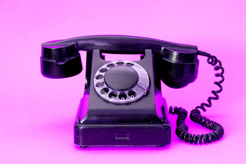 A vintage dial phone from the 80s in abstract vivid colors.  Retro style landline telephone art.