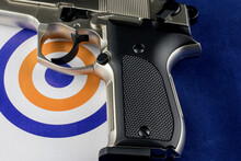 Automatic Pistol And Target On A Blue Background