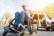 © romaset - A man in a wheelchair on a lift of a vehicle for people with disabilities
