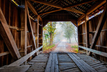 View Of Rural Road From Inside A Covered Bridge.