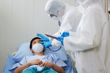 Medical team in Personal Protective Equipment or PPE clothing and Researching and Discussing Check up eyes for patients infected with the Covid 19 virus and treatment in hospital of Thailand