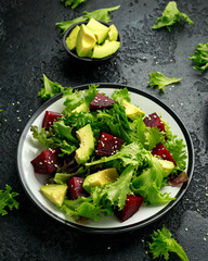 Wall Mural - Vegetarian avocado and beet salad in plate. Healthy vegan food