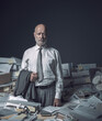 © stokkete - Stressed businessman overloaded with paperwork