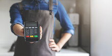 Noncash Payment - Waitress With Apron Standing In Cafe With Pos Terminal In Hand. Copy Space