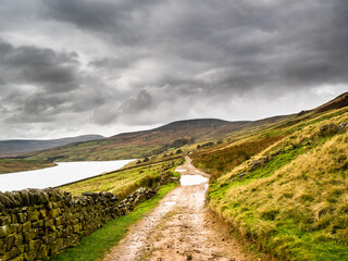 Wall Mural - A country track winds its way through moorland around Scar House reservoir.  Nidderdale. Yorkshire Dales