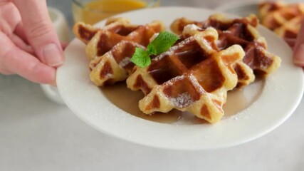 Wall Mural - Serving plate of belgian waffles with maple syrup, confectioner sugar. Sweet breakfast waffles